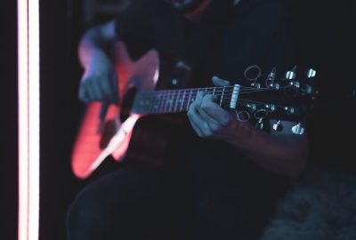 close-up-of-a-guitarist-playing-an-acoustic-guitar-in-a-dark-room-.jpg
